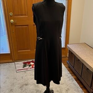 Never worn Calvin Klein size 8 sleeveless black dress.  Side gold detailing.